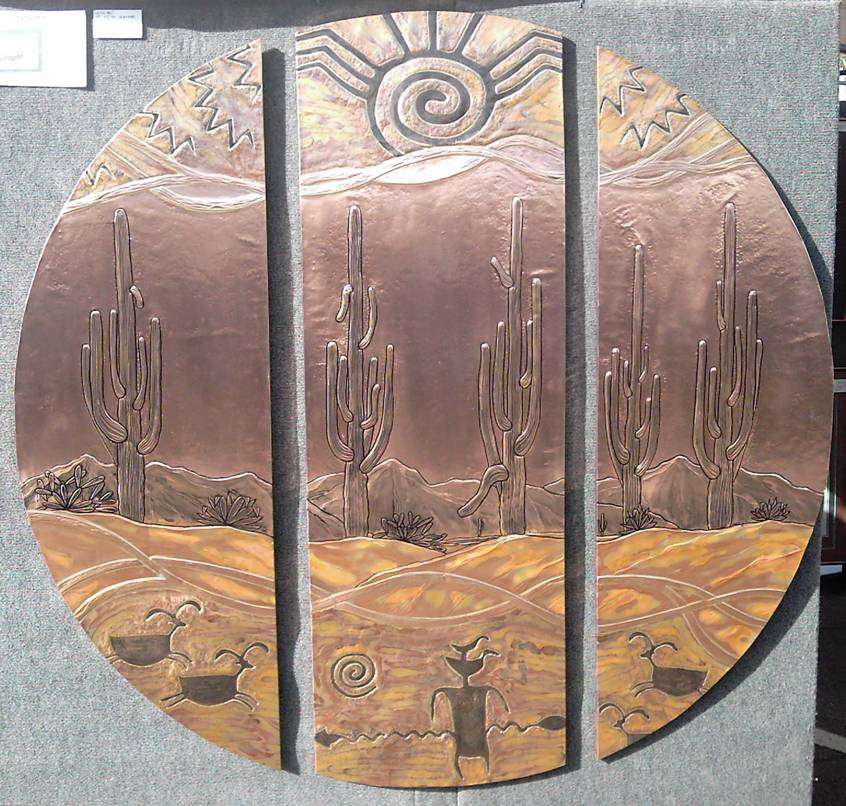 Saguaros, Sun Symbol, & Petroglyphs
Approximately 66 in Diameter
Copper wrapped around wood.  Although this piece is sold, one similar to it could be made for you. Your piece could be bigger or smaller, have different colors, different subjects, or have a different shape.
